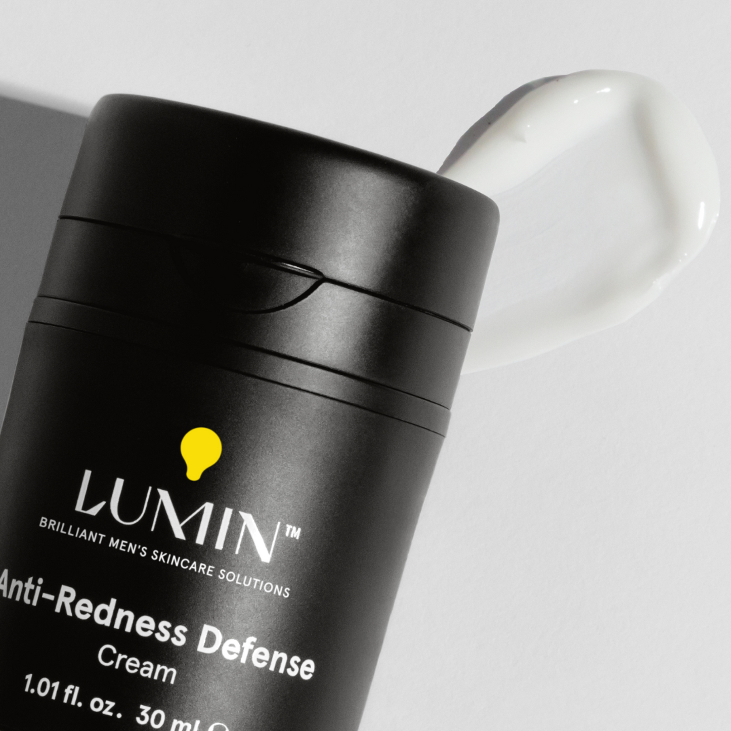 Lumin Anti-Redness Defense cream for men with smooth white moisturizer swatch on white background