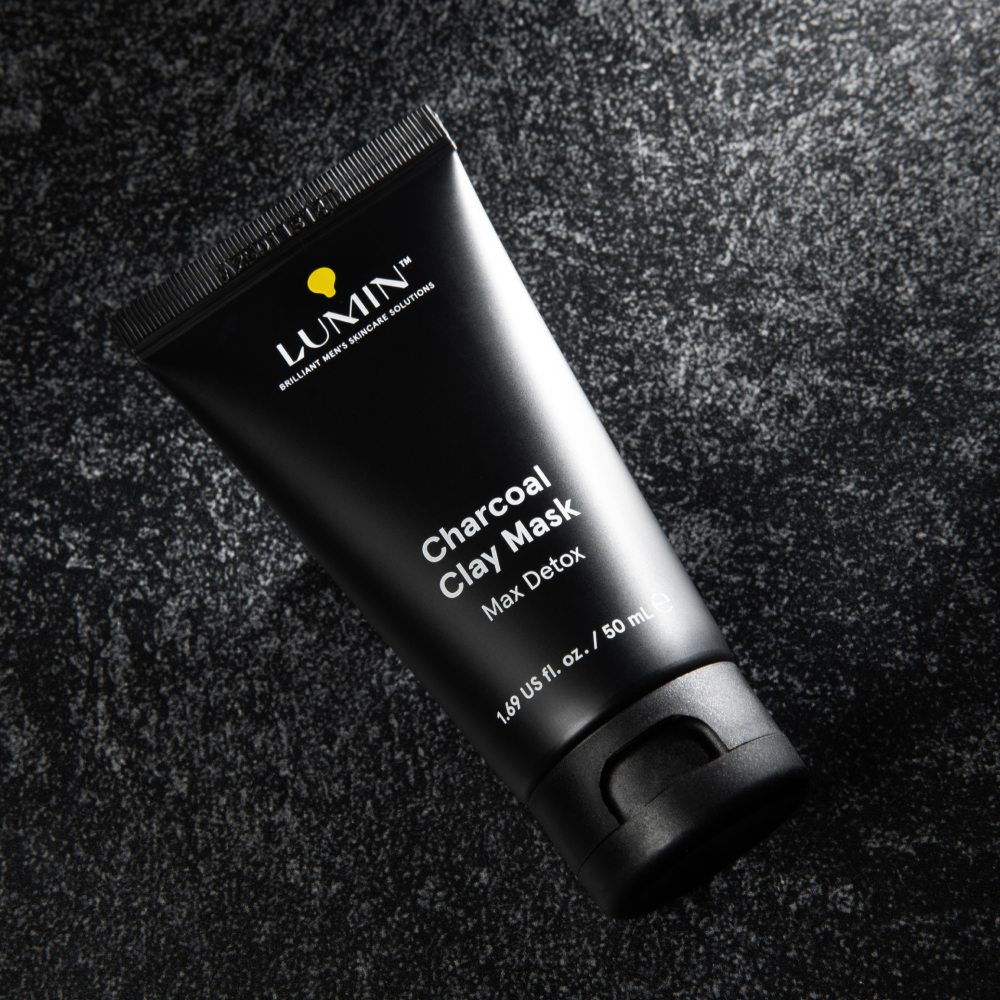 Lumin charcoal clay mask tube on textured dark surface, men's skincare detox face mask, 50ml packaging