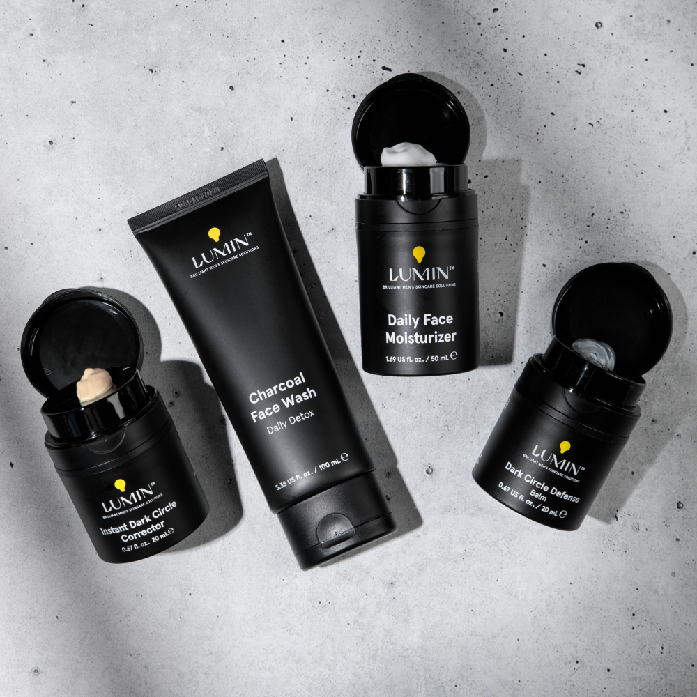Lumin men's skincare set with charcoal face wash, daily face moisturizer, dark circle defense balm, and instant dark circle corrector.