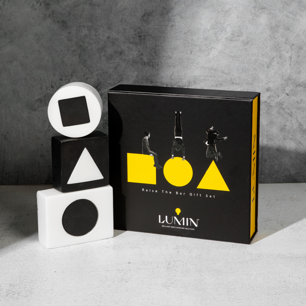 Lumin men's skincare Raise The Bar Gift Set with black and yellow box and geometric soap bars featuring circle, triangle, and square shapes.
