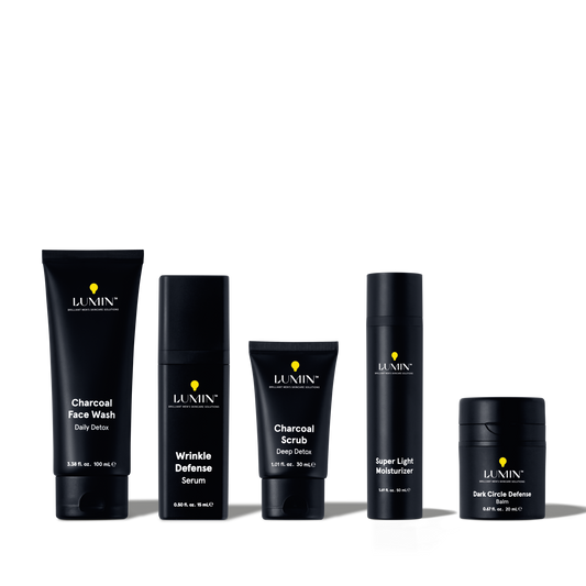 Lumin men's skincare set featuring charcoal face wash, wrinkle defense serum, charcoal scrub, super light moisturizer, and dark circle balm