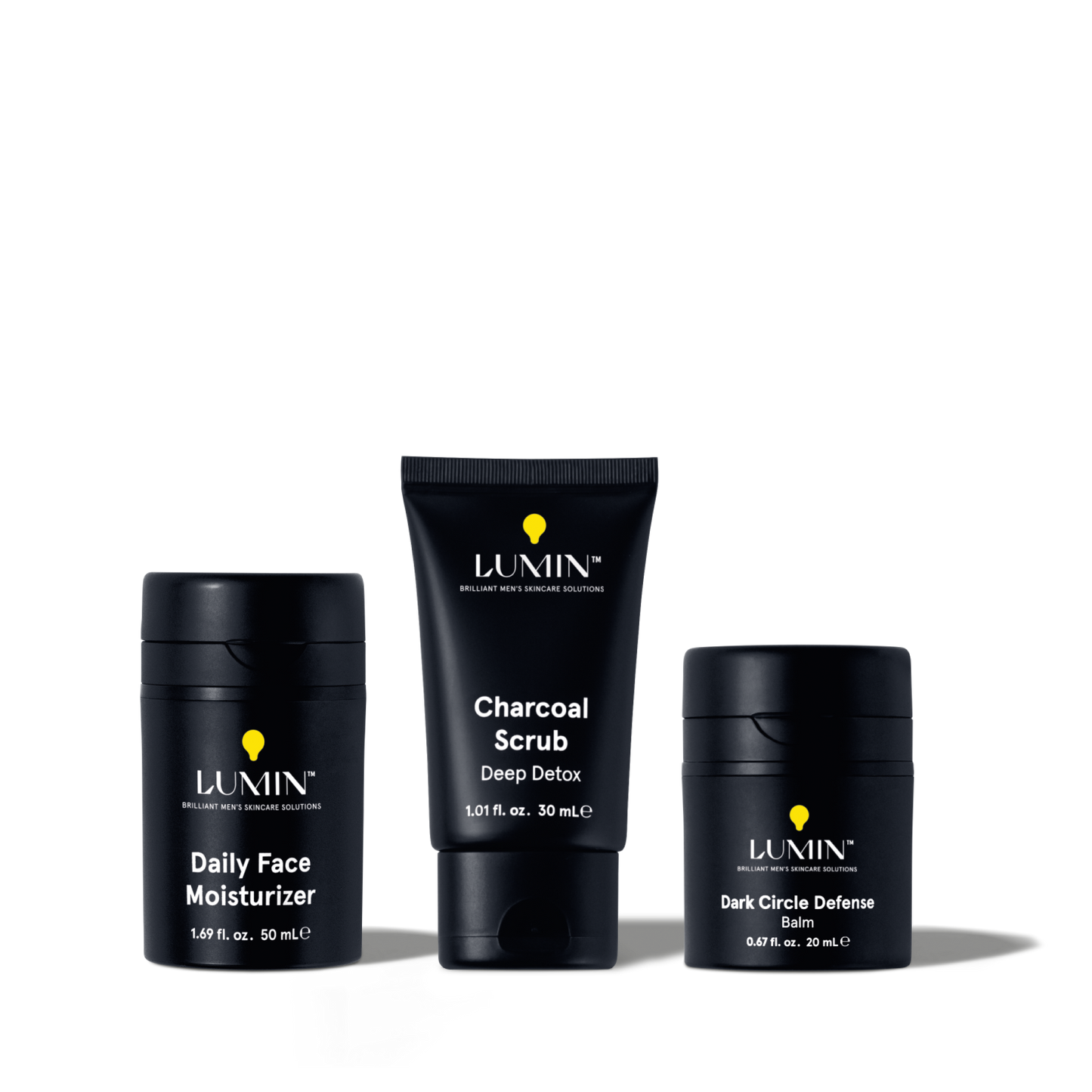 Lumin men's skincare set featuring Daily Face Moisturizer, Charcoal Scrub Deep Detox, and Dark Circle Defense Balm.