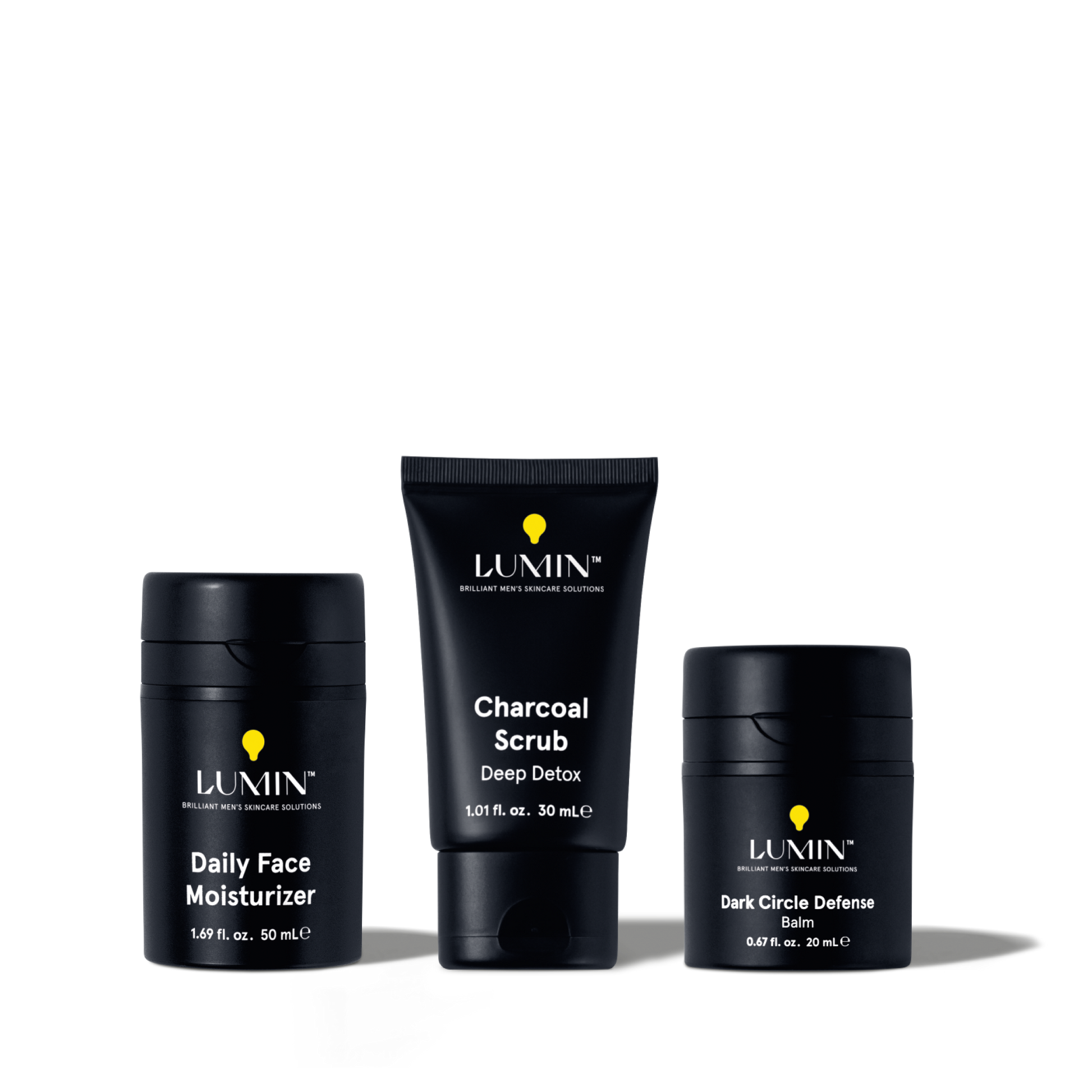 Lumin men's skincare set featuring Daily Face Moisturizer, Charcoal Scrub Deep Detox, and Dark Circle Defense Balm.