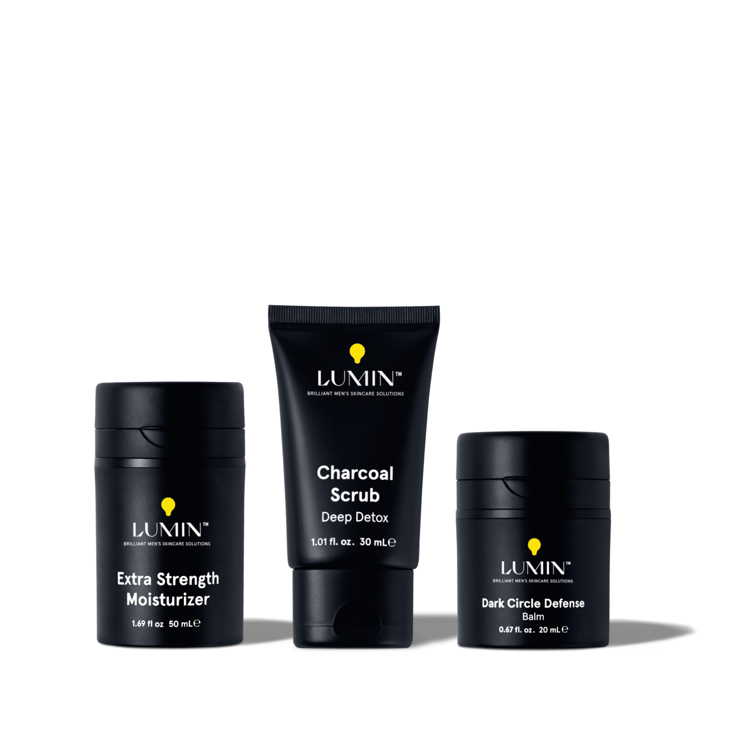 Lumin men's skincare set with Extra Strength Moisturizer, Charcoal Scrub Deep Detox, and Dark Circle Defense Balm.