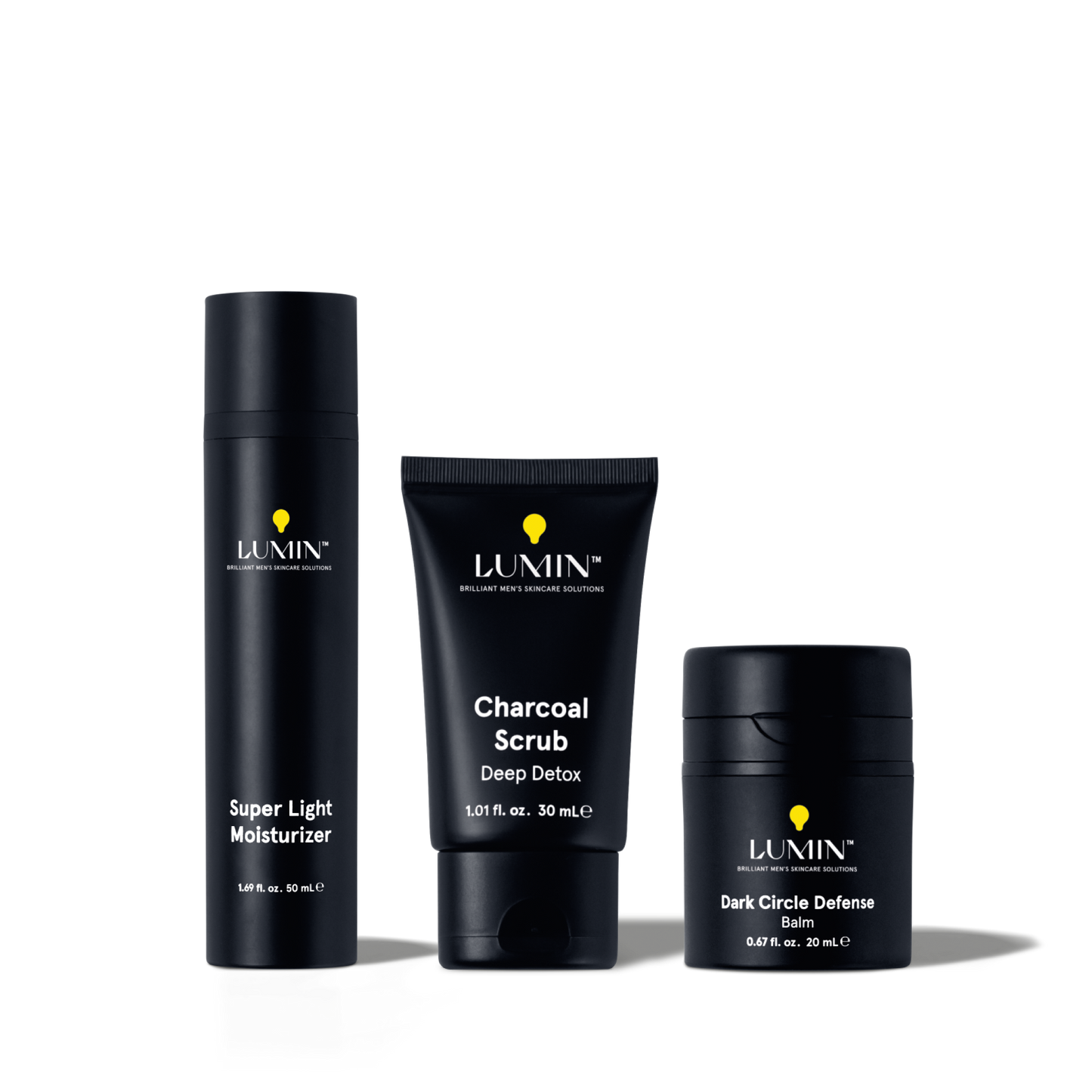 Lumin men's skincare set with Super Light Moisturizer, Charcoal Scrub Deep Detox, and Dark Circle Defense Balm.