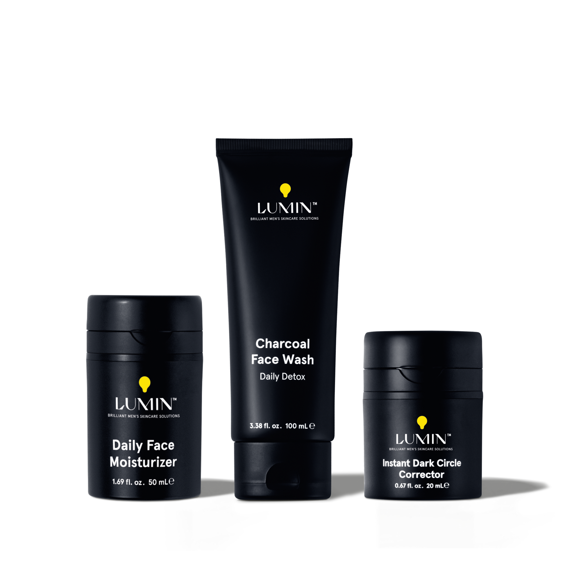 Lumin men's skincare set with charcoal face wash, daily face moisturizer, and instant dark circle corrector in black packaging