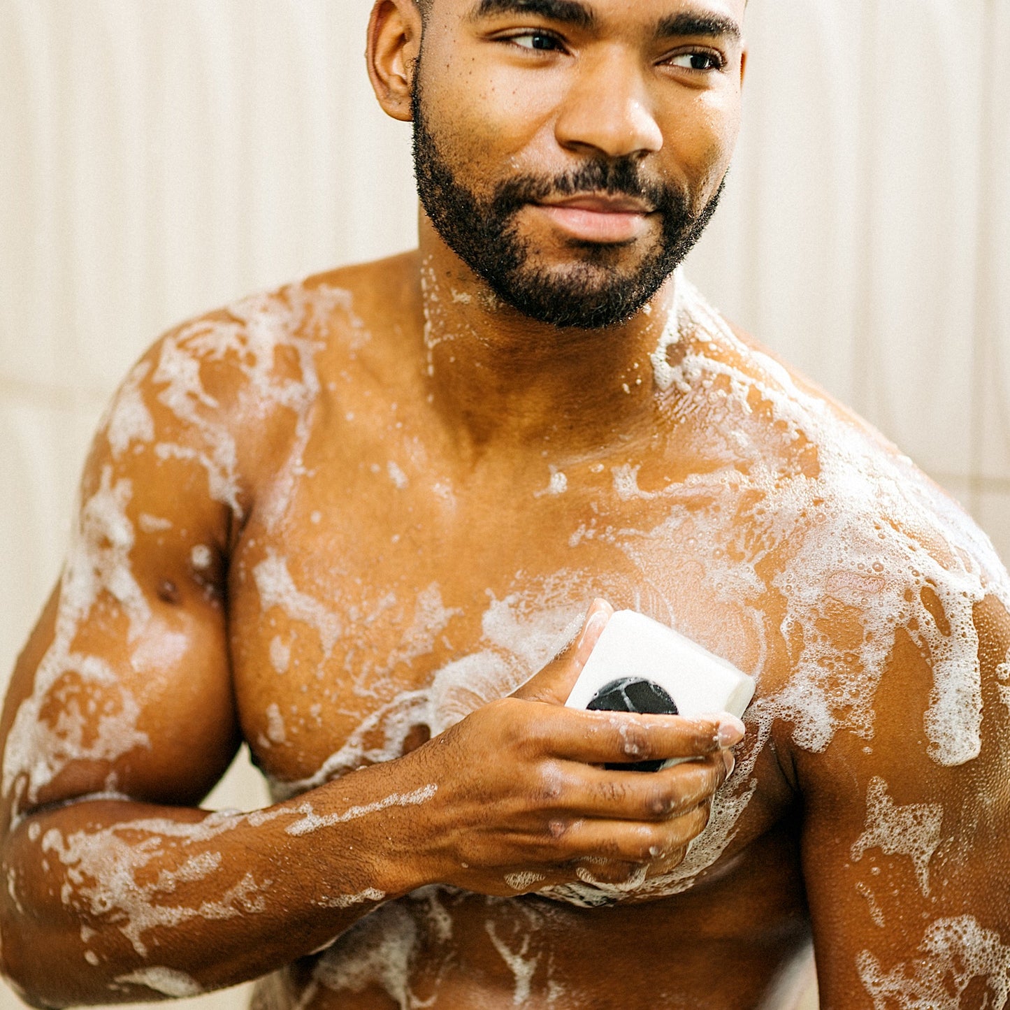 lumin pdp deep cleanse and scrub body bar in use