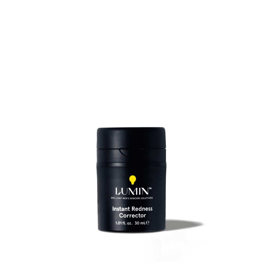 Lumin Instant Redness Corrector skincare product for men, 1.01 fl. oz. black travel-size container with yellow logo.