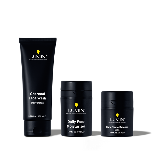 Lumin men's skincare set with Charcoal Face Wash, Daily Face Moisturizer, and Dark Circle Defense Balm in black packaging