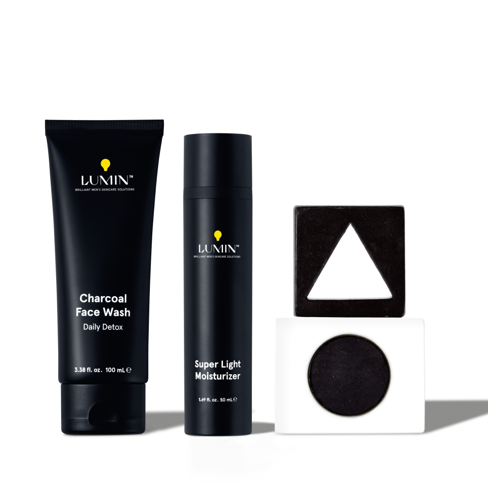 Lumin men's charcoal face wash and super light moisturizer with geometric skincare containers, black and white design.