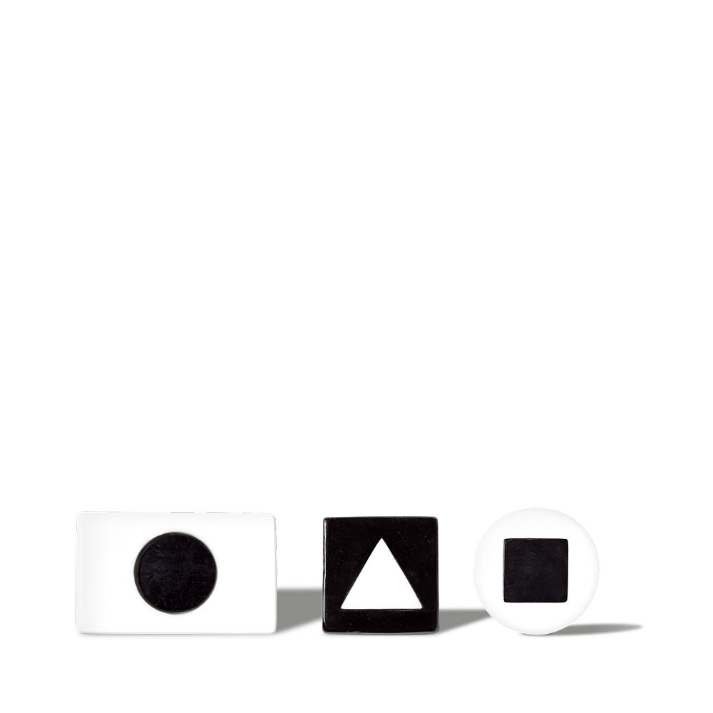 White and black geometric shape blocks with circle, triangle, and square cutouts on black background for educational use.